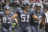 SEATTLE WA - DECEMBER 05:  Linebacker Lofa Tatupu #51 of the Seattle Seahawks celebrates with Jay Richardson #99 and Craig Terrill #93 after returning an interception for a touchdown against the Carolina Panthers at Qwest Field on December 5 2010 in Seattle Washington. The Seahawks defeated the Panthers 31-14. (Photo by Otto Greule Jr/Getty Images)